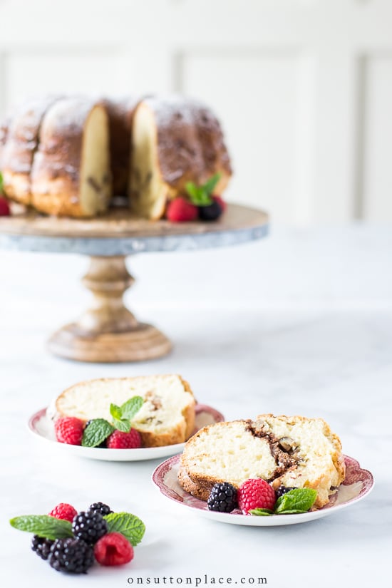 coffee cake on wood stand with slices on plates
