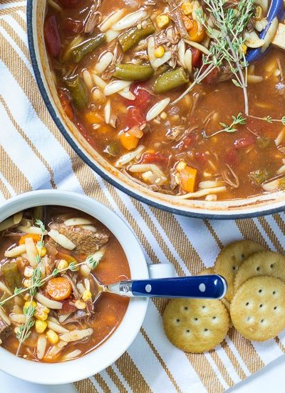 one pot easy vegetable soup in pot with bowl fi