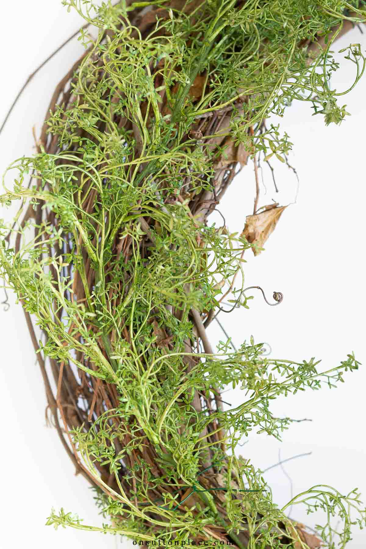 how to make a wreath add greenery to grapevine base