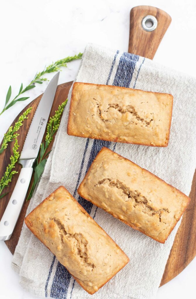 3 mini loaves of applesauce bread on round wood board