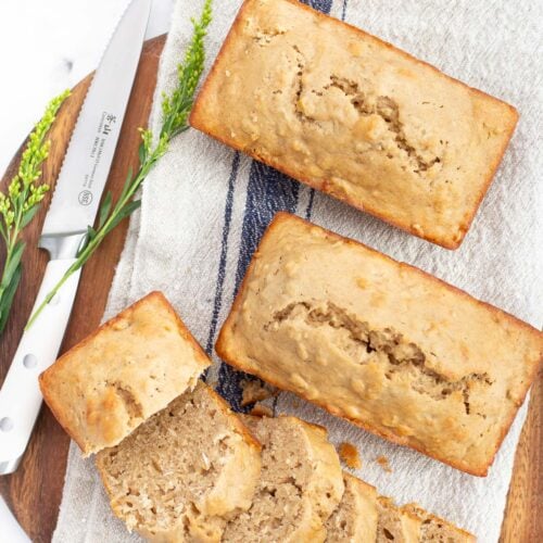 applesauce bread on round wood board with knife