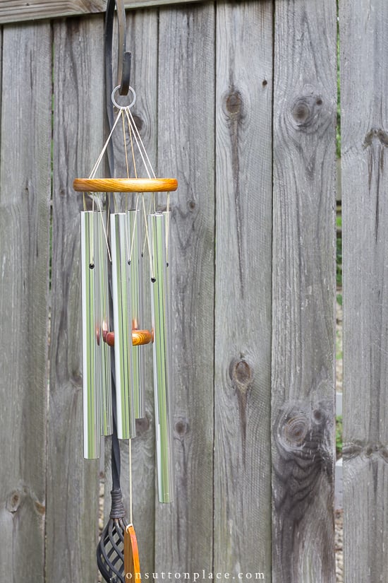 Easy garden art ideas that show you how to add your own personal style to your garden through garden art. Budget friendly options included! wind chines on shepherds hook 2021