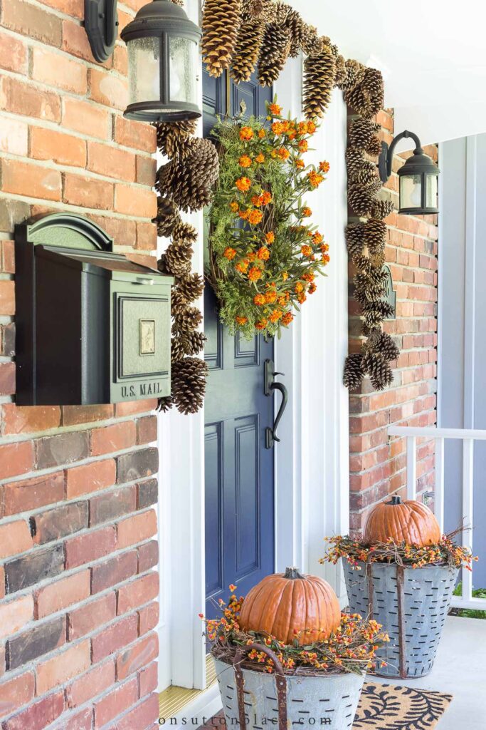 fall front door with pumpkin planters 2022