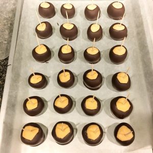 finished peanut butter buckeyes on baking sheet