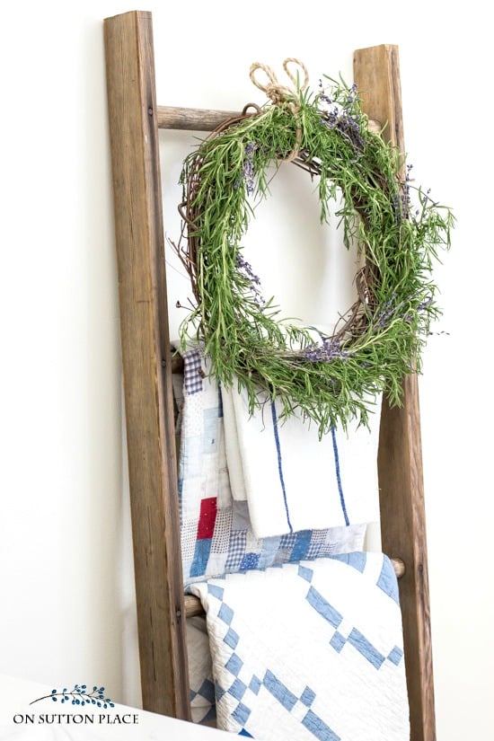 blanket ladder with quilts and wreath
