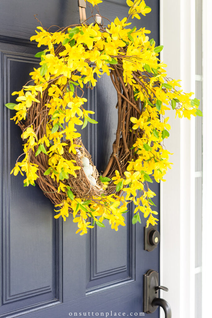 spring forsythia wreath on blue door 2022