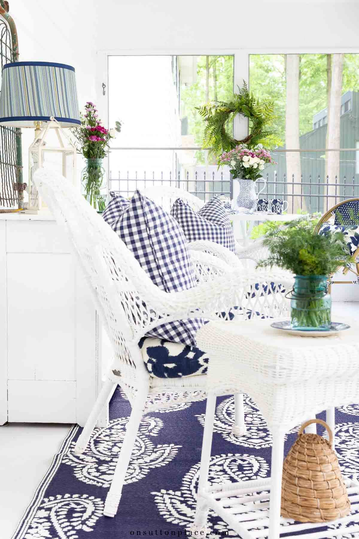 blue and white screened in porch seating area with outdoor rug 2