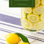 lemon slices and flowers arranged in clear vase pin with text box