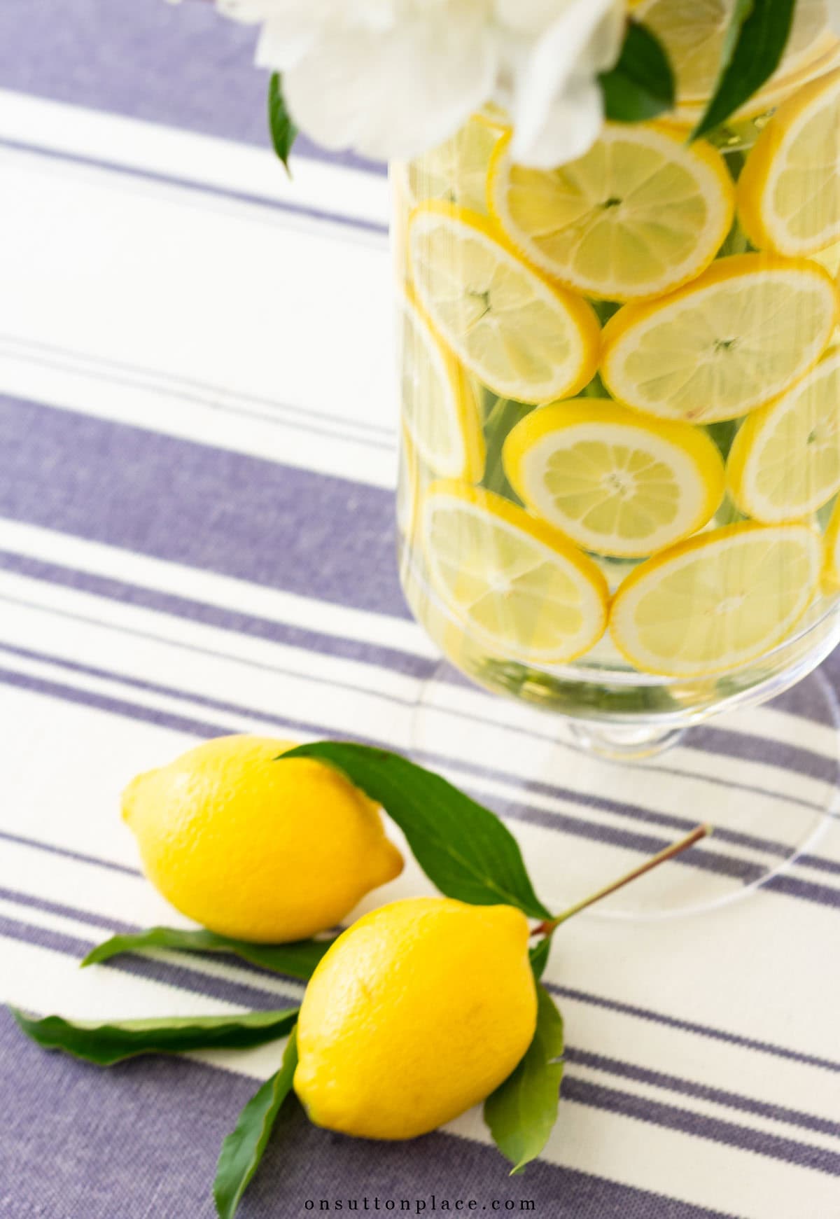 lemons in glass vase with flowers wedding centerpiece idea