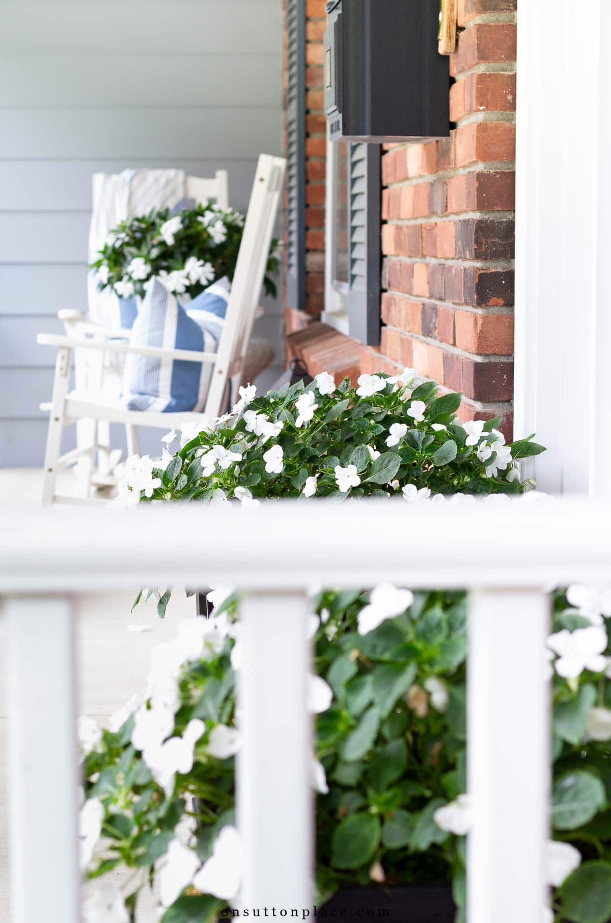 front porch with white impatiens in planters