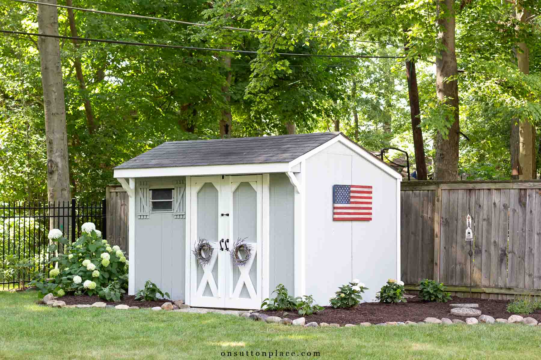 outdoor storage shed in backyard with surrounding garden