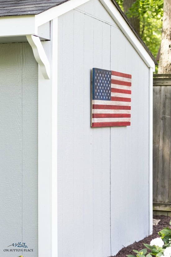 wood american flag on side of storage shed