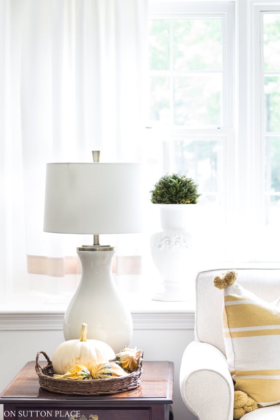 diy fall decor ideas pumpkin in basket on side table
