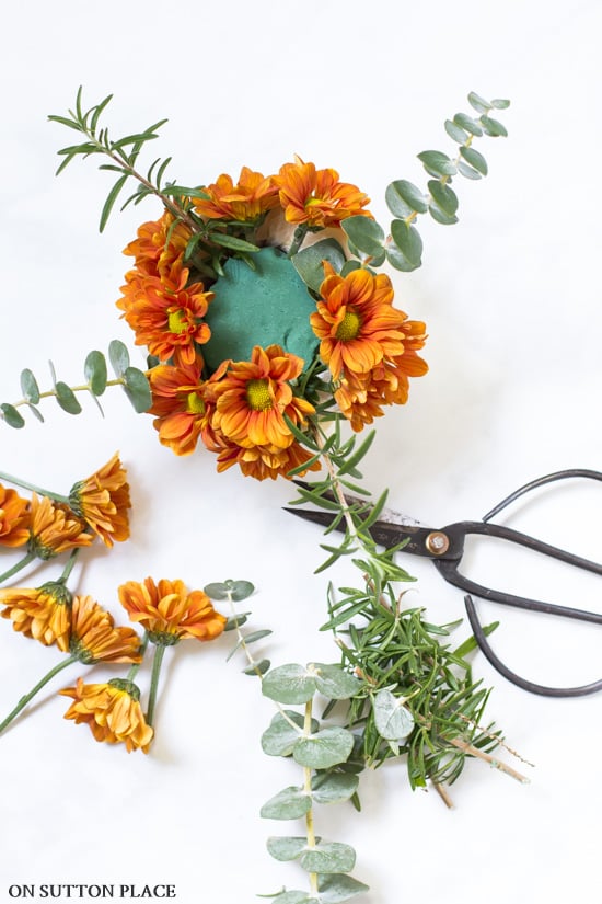mini pumpkin flower arrangement assembly with scissors