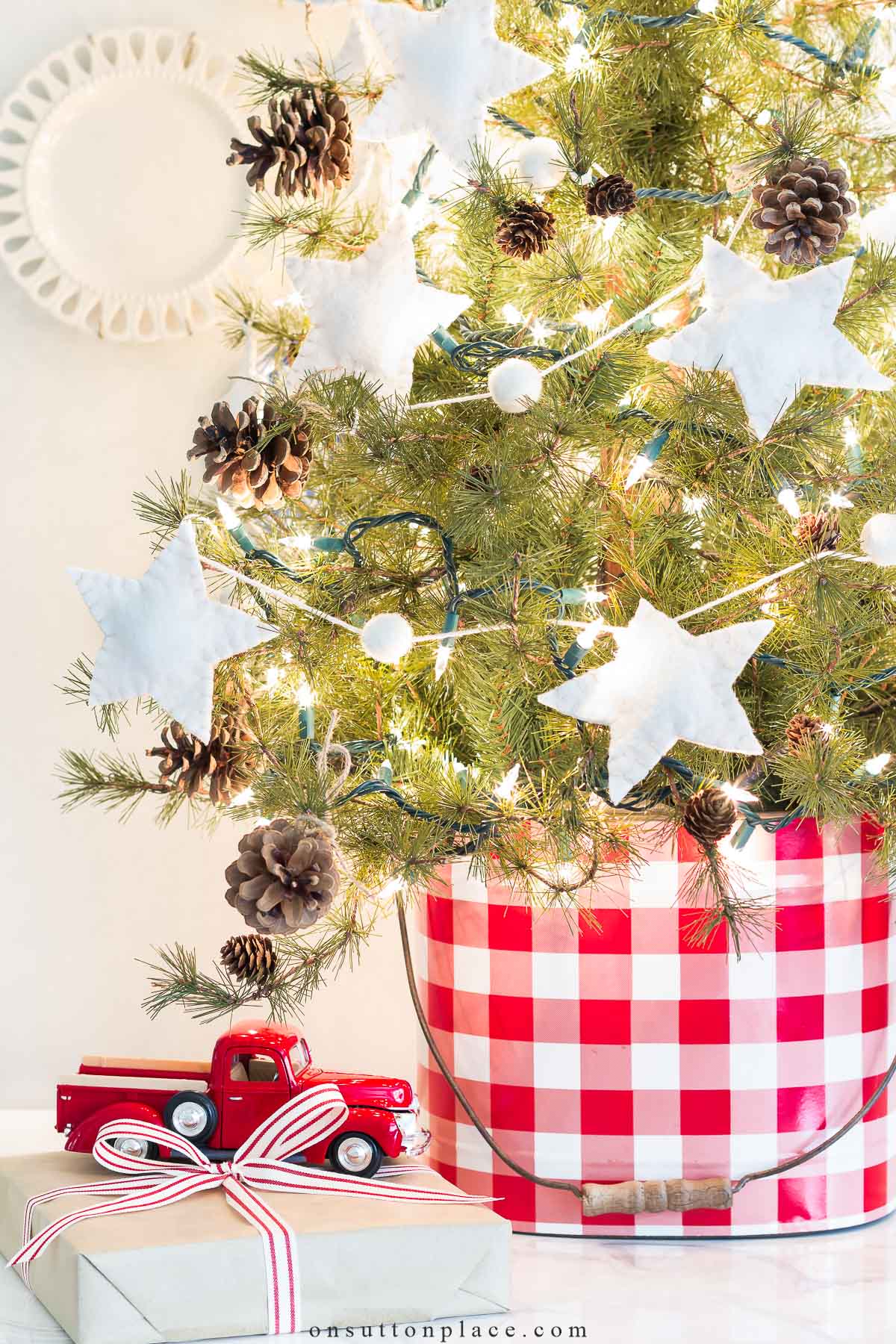 star christmas tree garland on mini tree in gingham bucket