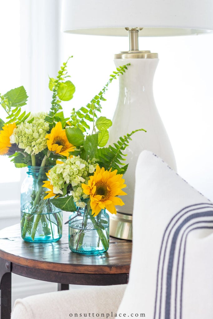 sunflowers in mason jars on end table
