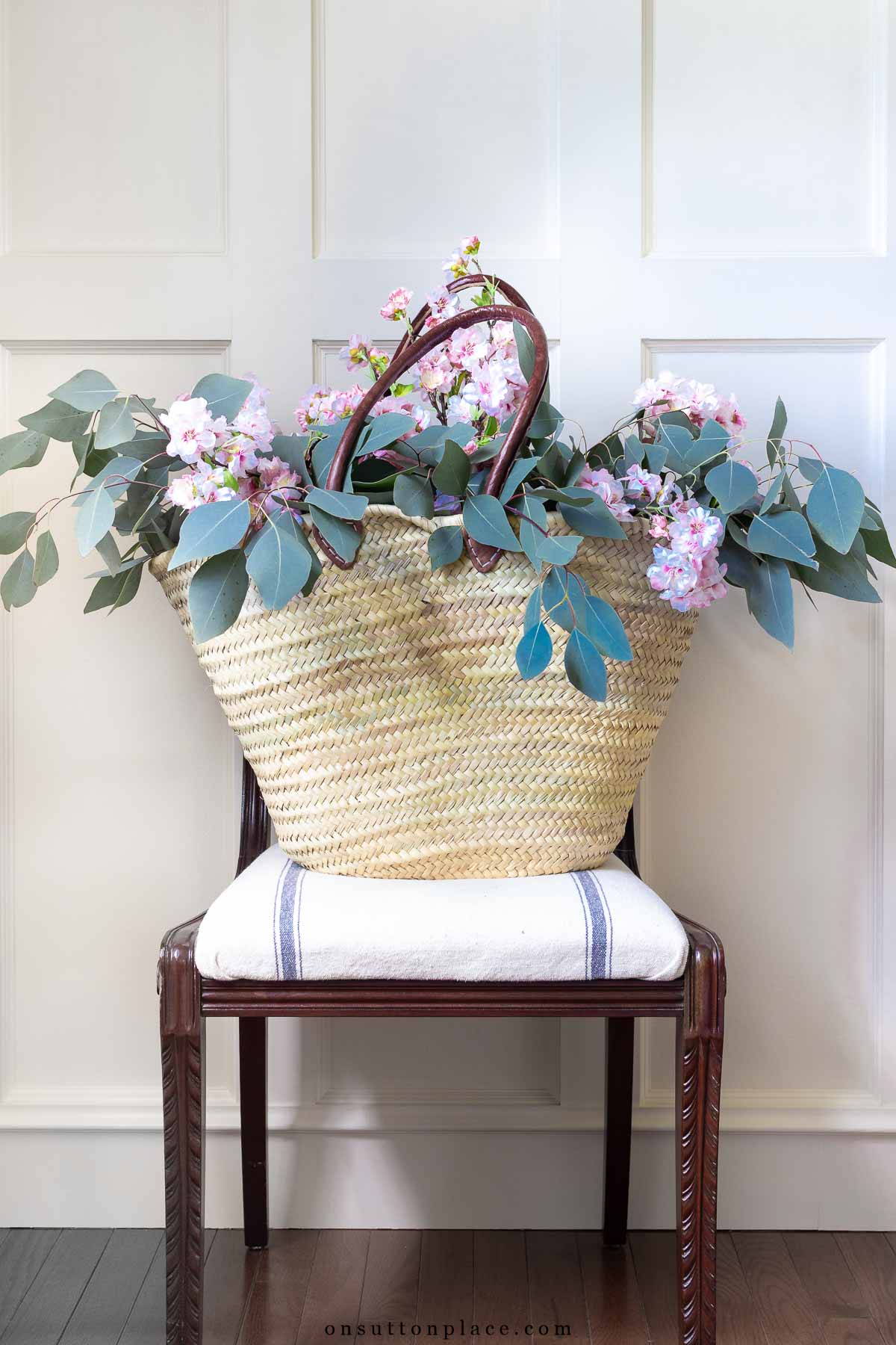 basket decor ideas market basket with cherry blossoms on vintage chair grain sack fabric