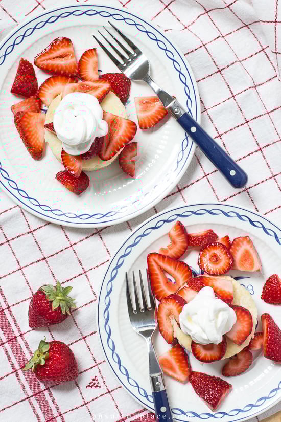 strawberry shortcake on plates with whipped cream