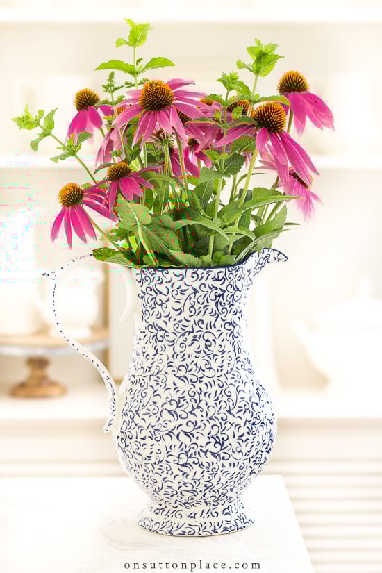 blue and cream pitcher with flowers