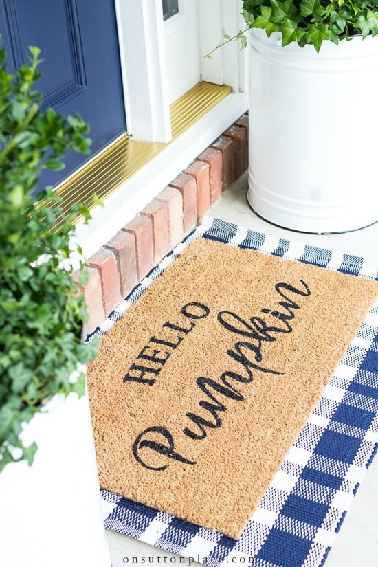 hello pumpkin doormat over plaid rug