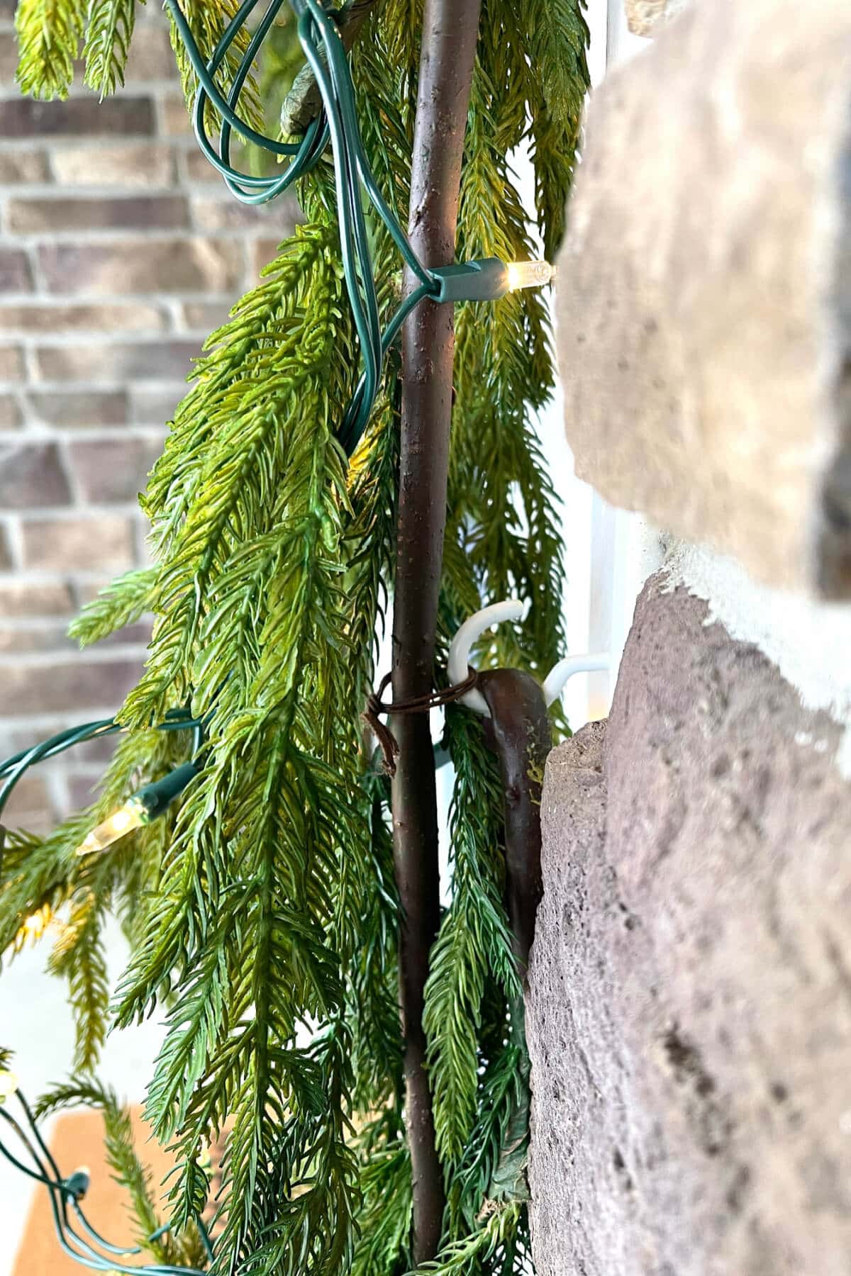 christmas garland attached to cup hook around door