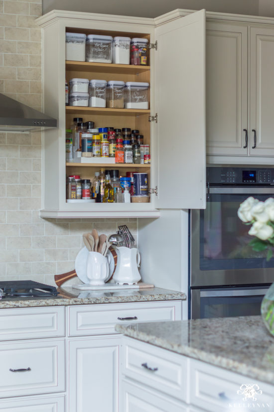 organized spices in kitchen cabinet