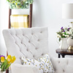 neutral tufted chair with yellow floral spring pillow