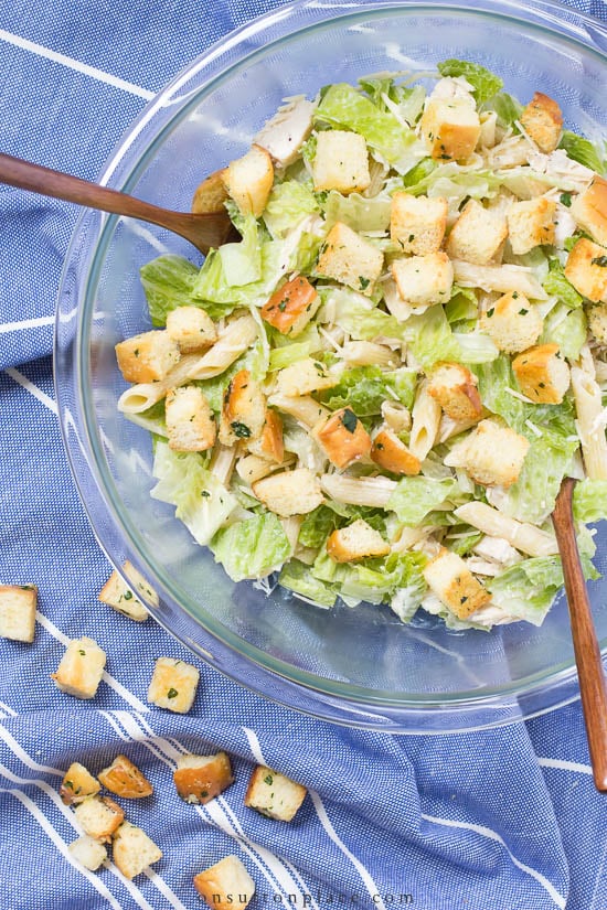 Easy and refreshing Chicken Caesar Pasta Salad recipe that goes together in no time. Serve it as a main course or side salad! #chickenrecipe #pastasalad #recipe #chickensalad chicken caesar pasta salad in pyrex bowl