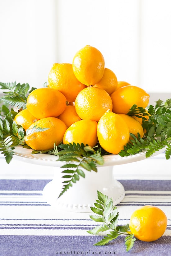 Make this fresh and beautiful meyer lemon centerpiece with items found at the grocery store, and in way under 20 minutes! #centerpiece #centerpieceidea #fruitcenterpiece #meyerlemon meyer lemon centerpiece on pedestal