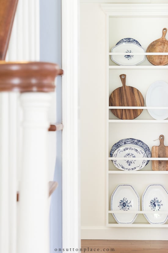 stairway banister and plate rack at end of hall