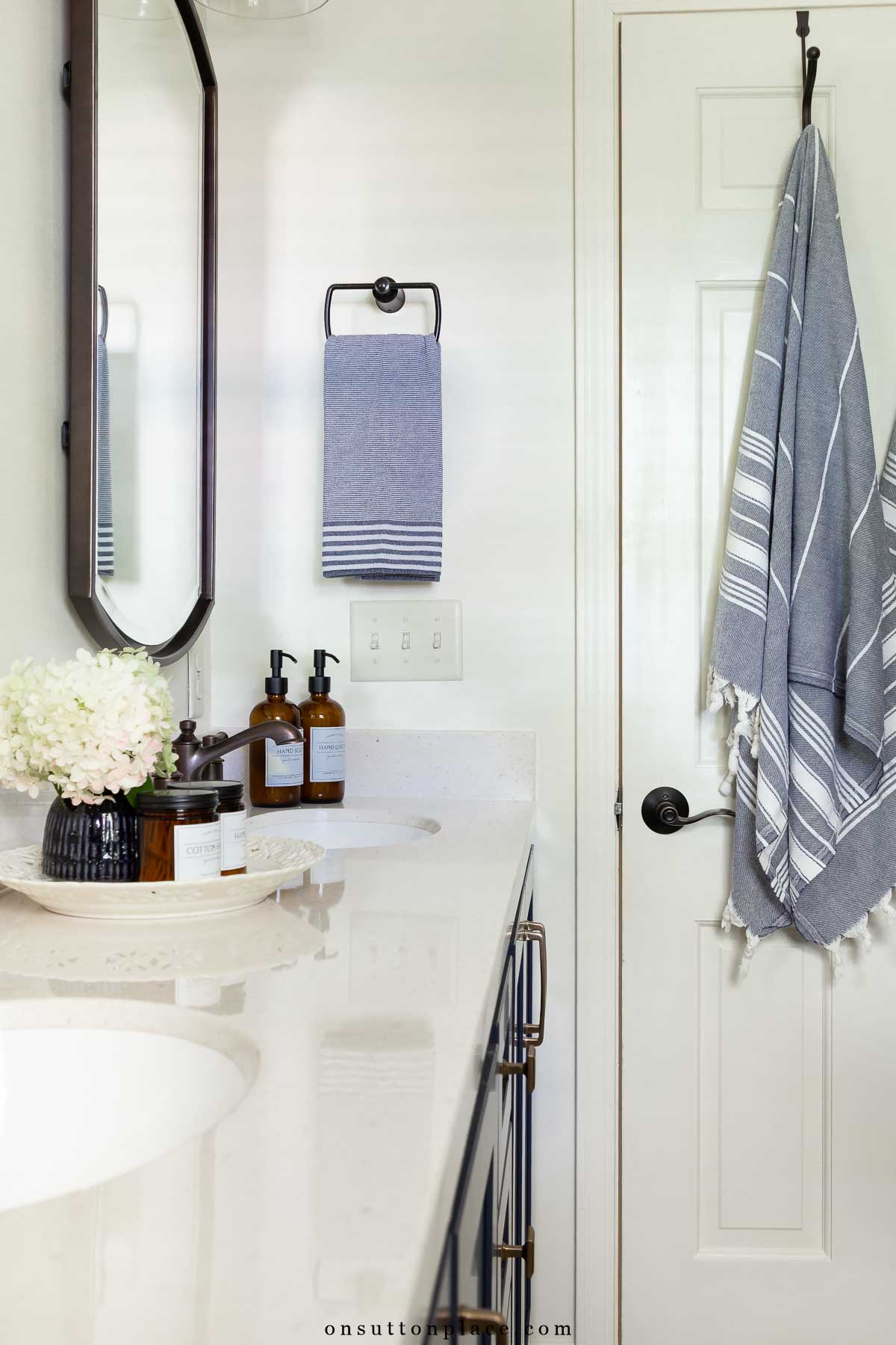 small bathroom remodel neutral countertop navy blue cabinets