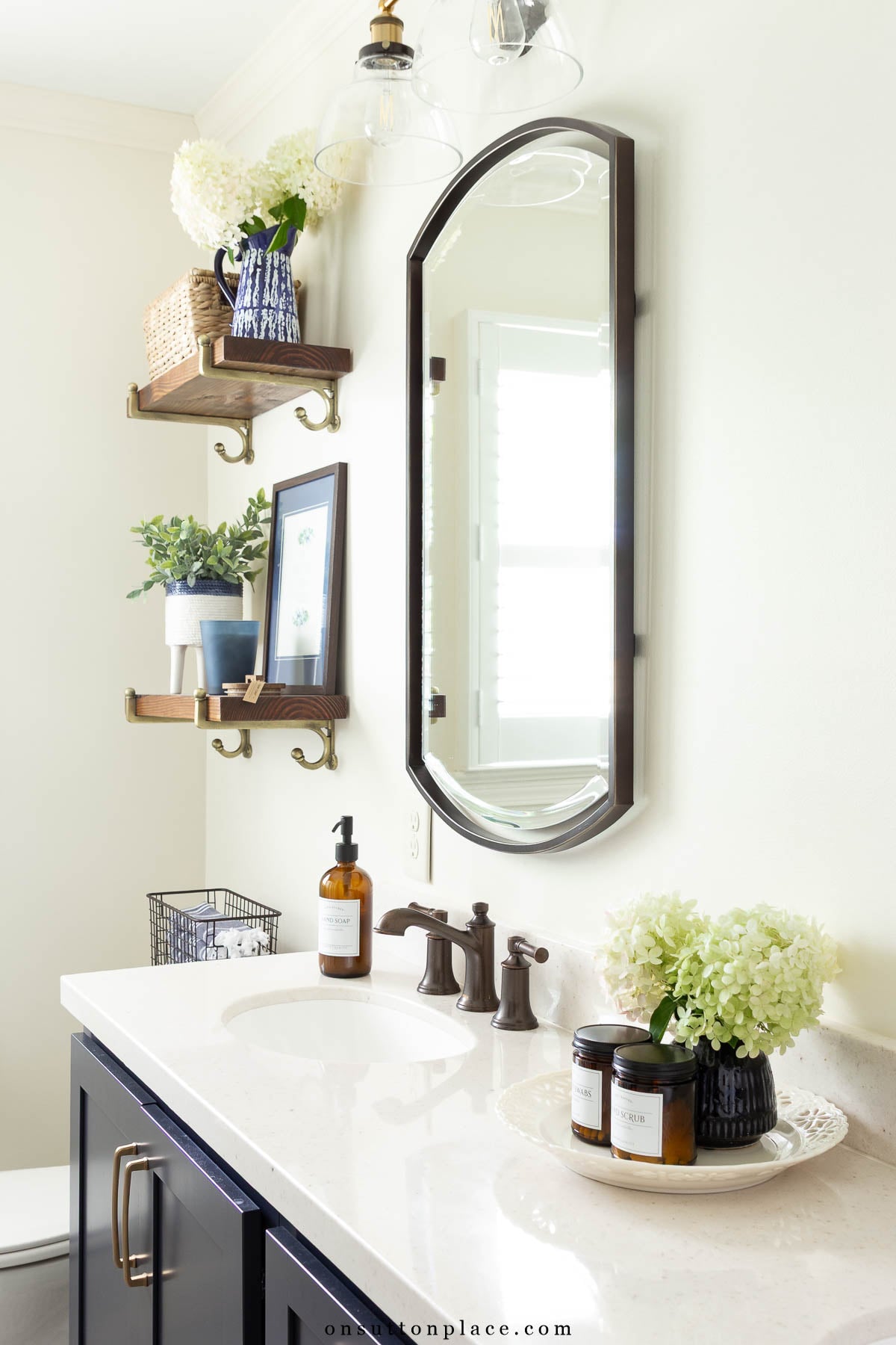 small bathroom remodel neutral countertops navy cabinets
