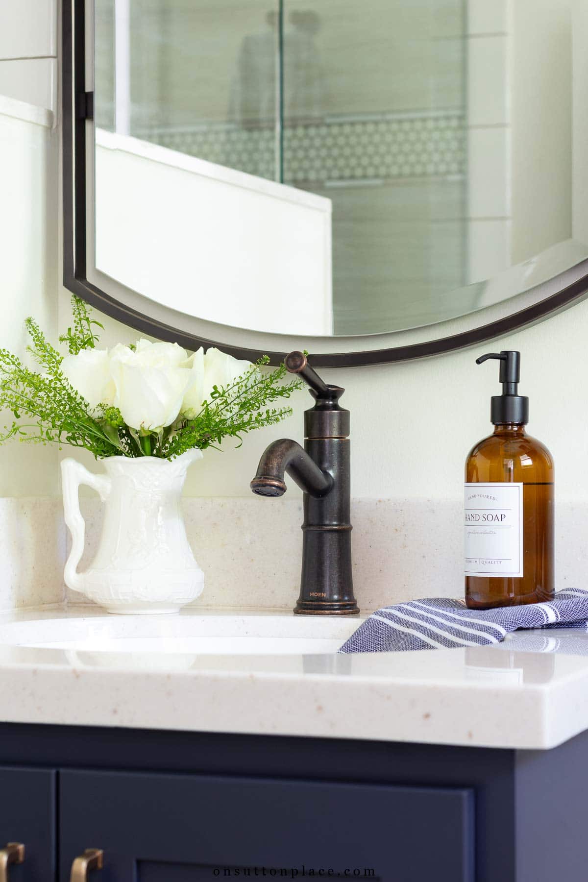 small primary bathroom remodel cultured granite countertop oil rubbed bronze faucet