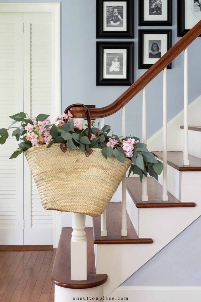 French market basket on stairway banister in foyer