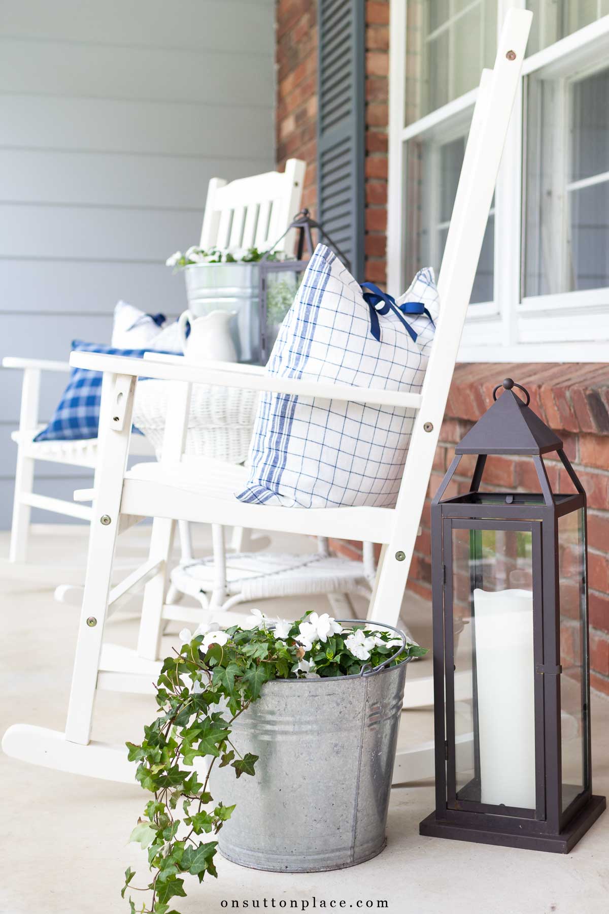 simple front porch on colonial home white rockers