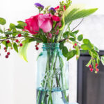 summer flowers in large vintage blue ball jar