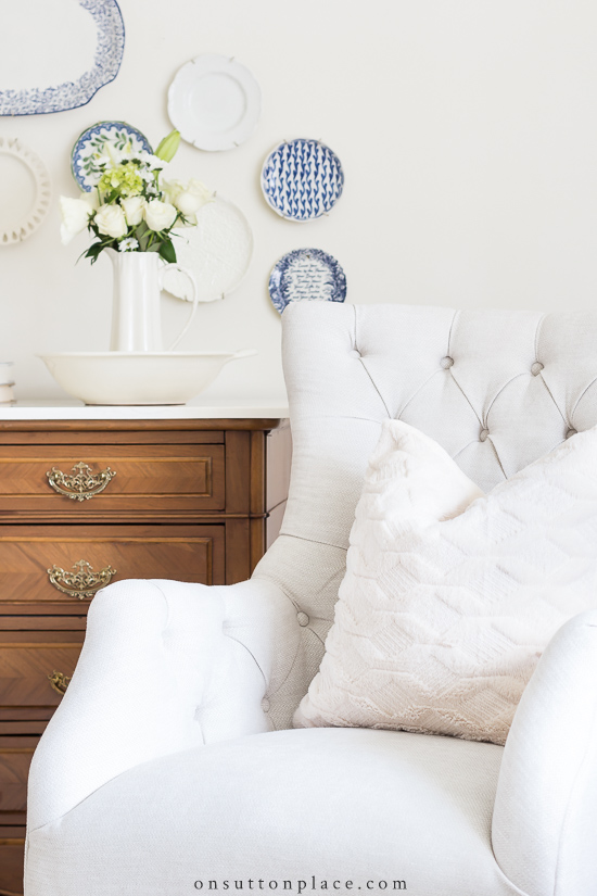 neutral pillow on tufted chair