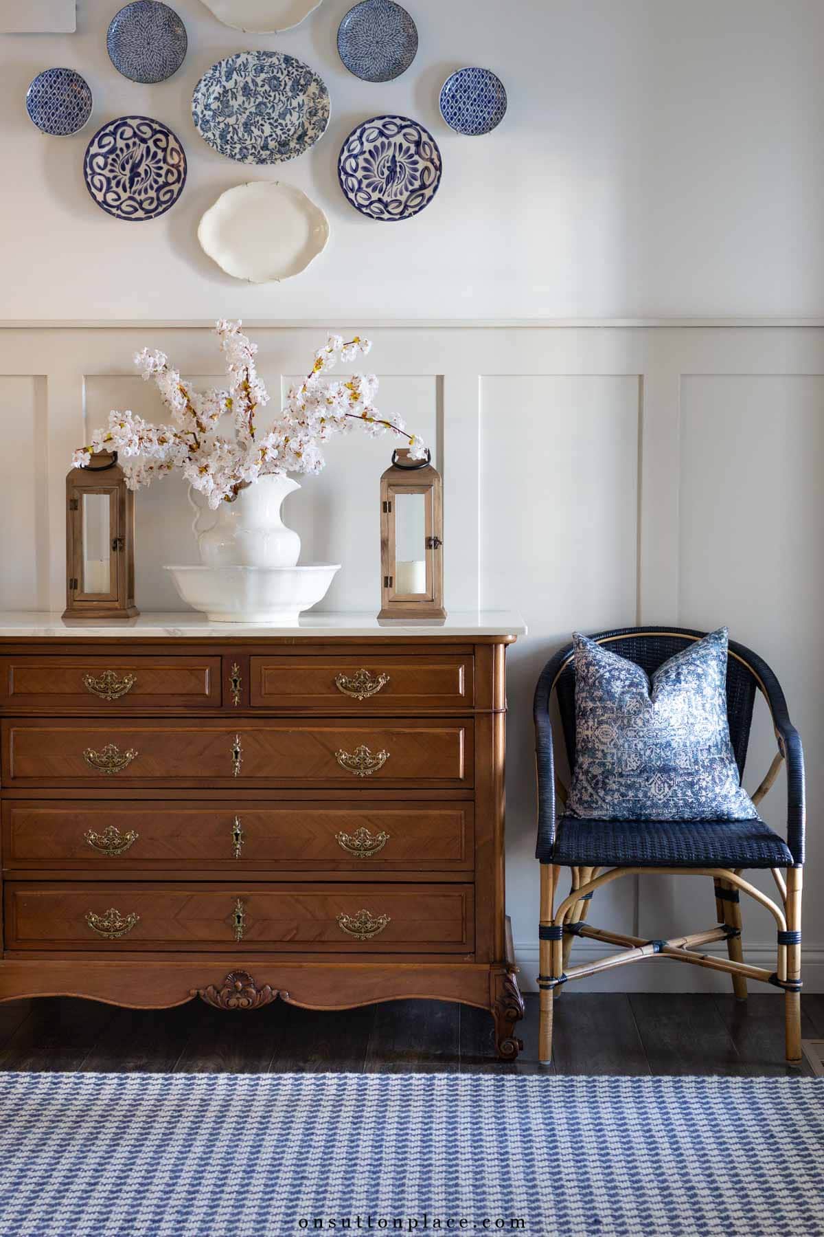 vintage dresser in entryway with board and batten faux cherry blossoms in pitcher