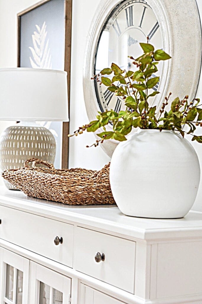 neutral decor on sideboard with clock