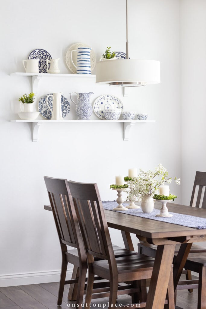 dining nook with shelves table and chairs