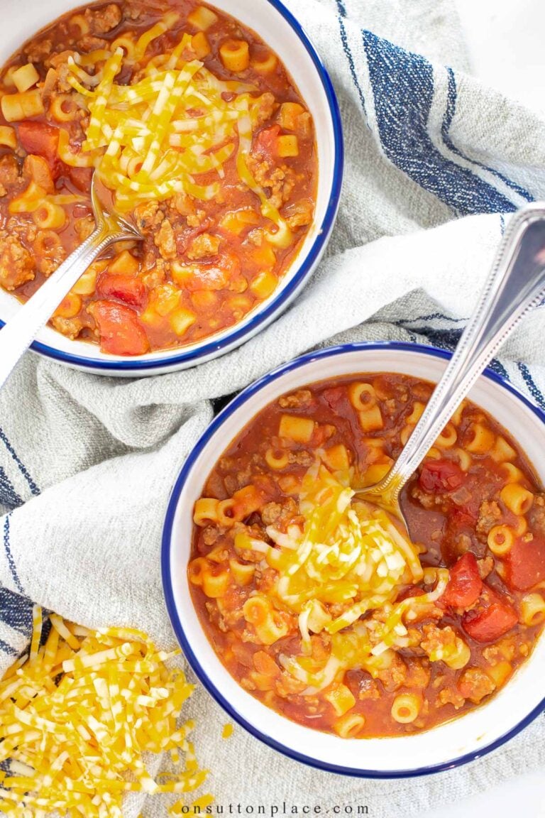 bowls of chili mac with shredded cheese