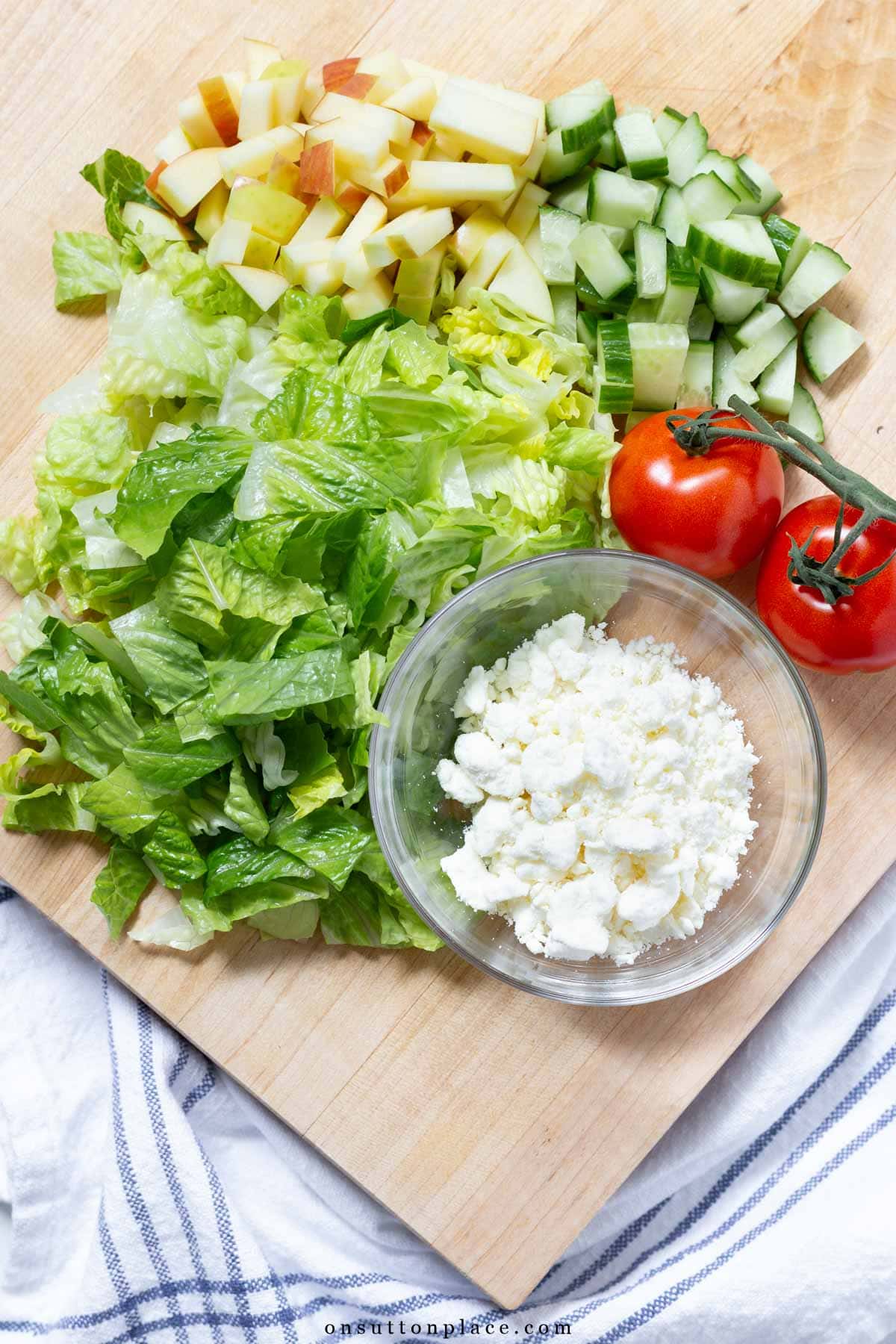 romaine salad recipe with apples and feta ingredients on wood board