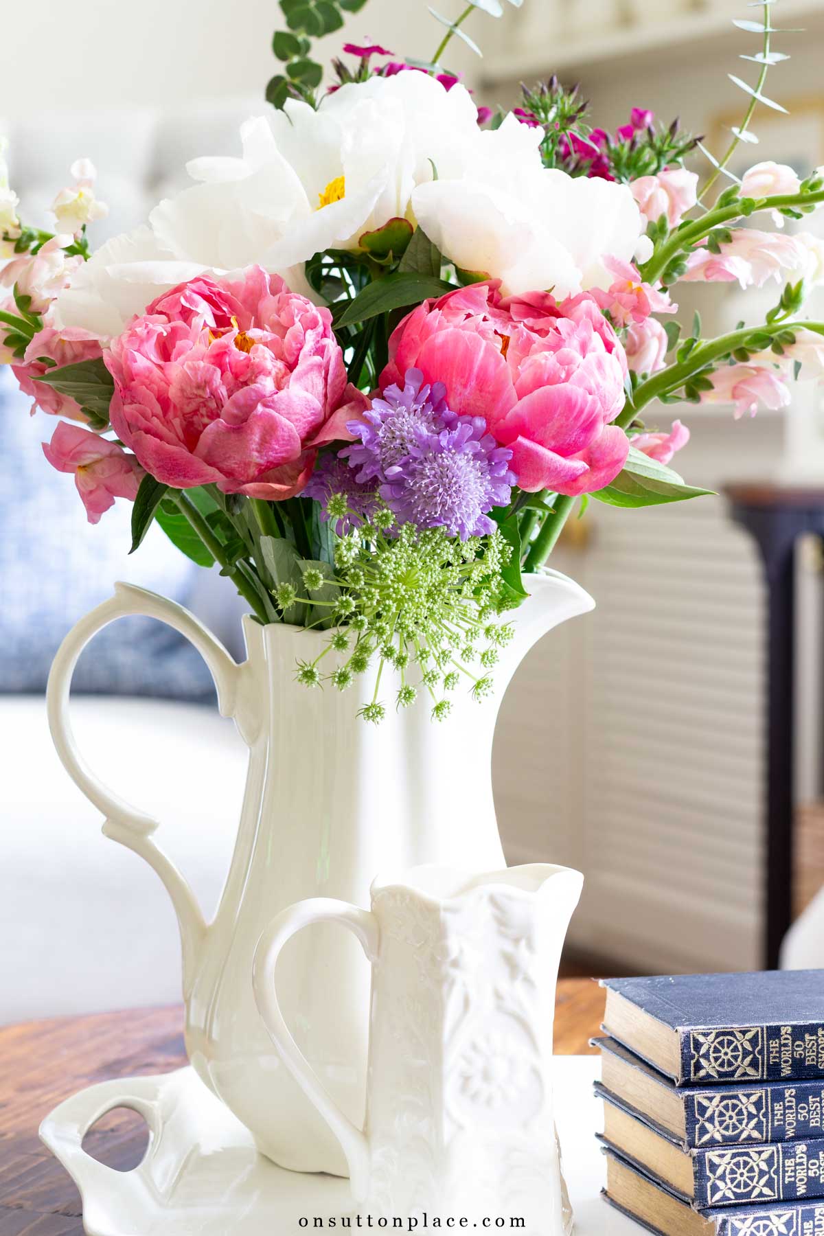 bouquet of garden flowers in ivory ironstone pitcher on coffee table