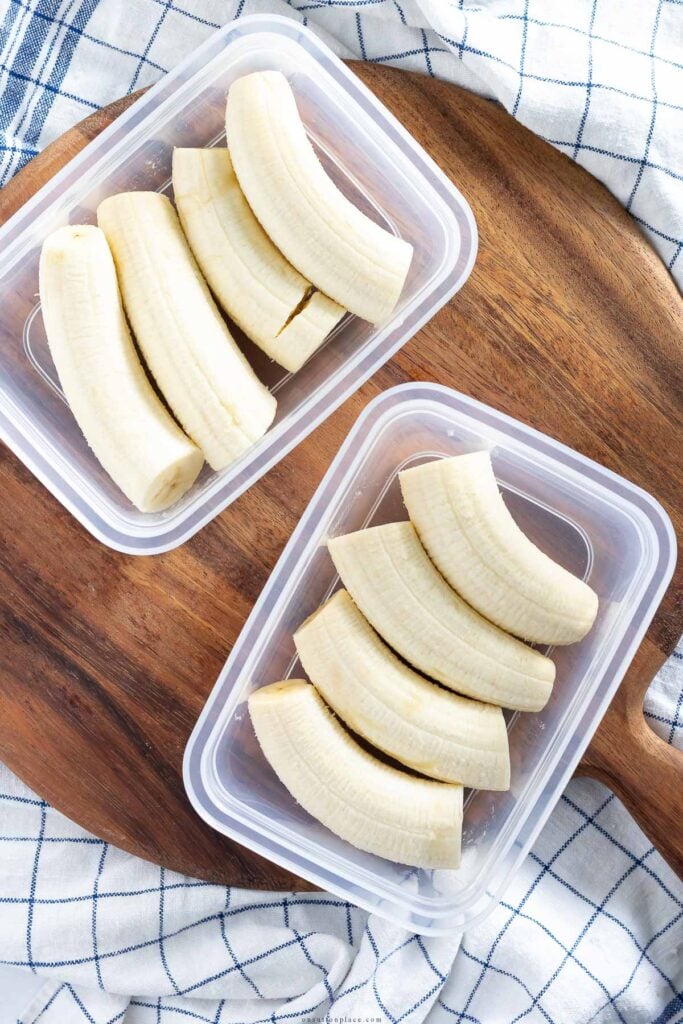 halved bananas in freezer safe container