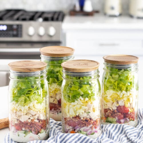meal prep salads in mason jars with wood lids