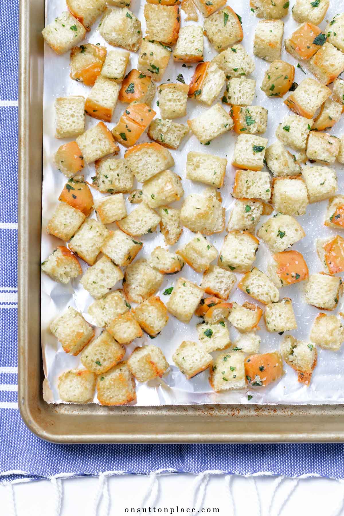homemade croutons recipe on baking sheet with parchment paper