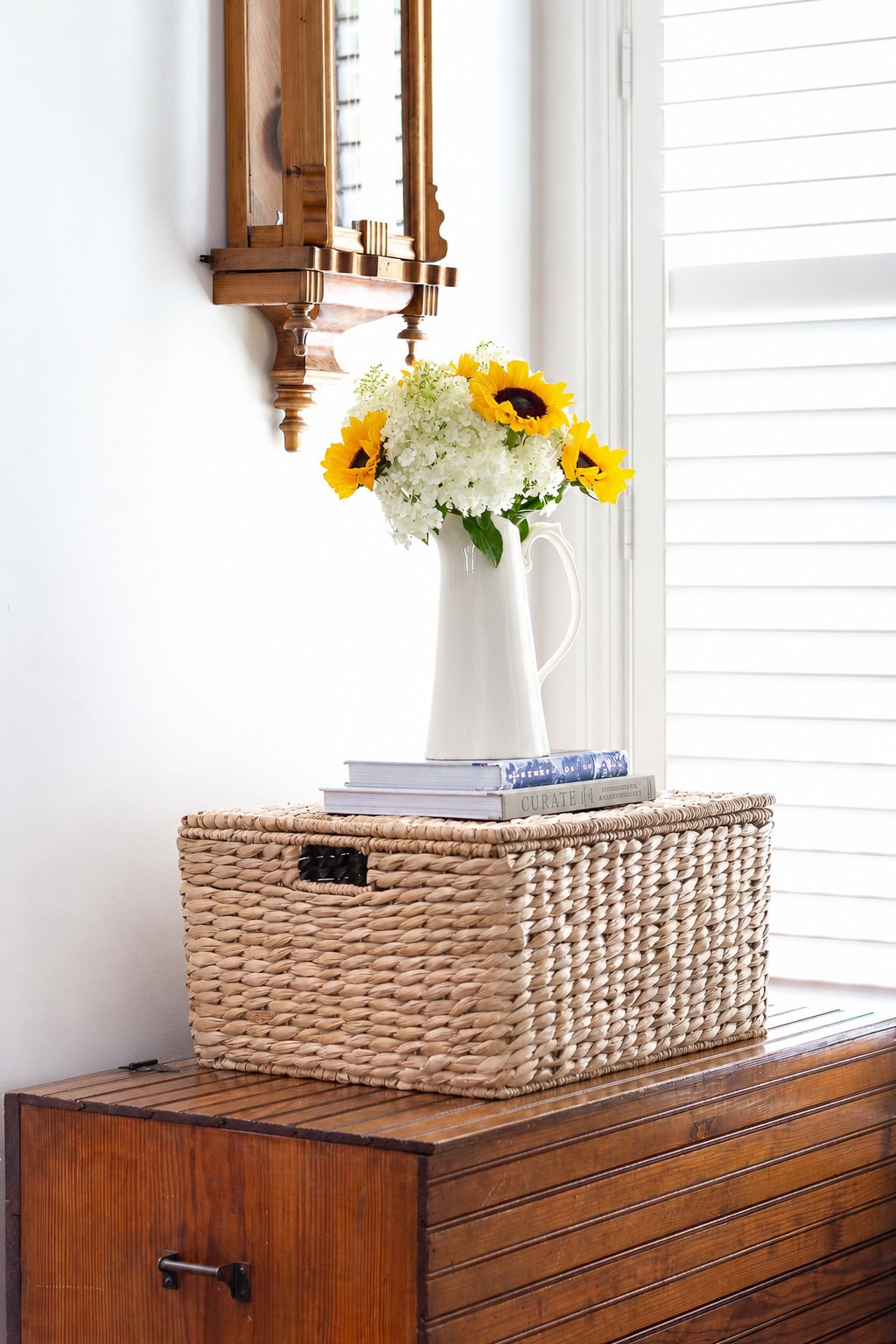 sunflower and hydrangea arrangement on blanket chest lightswitch removed