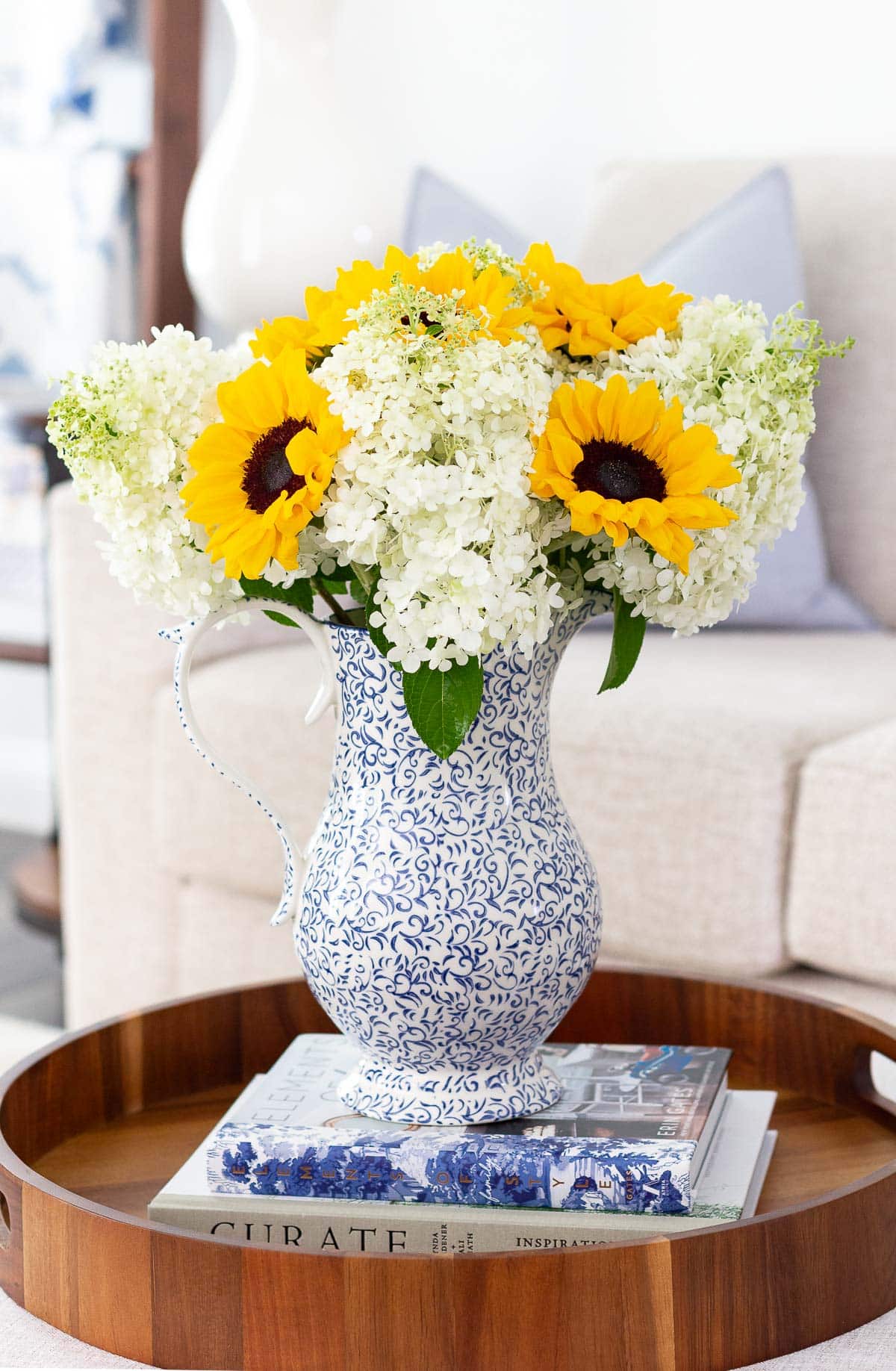 sunflower and hydrangea arrangement on coffee table with tray