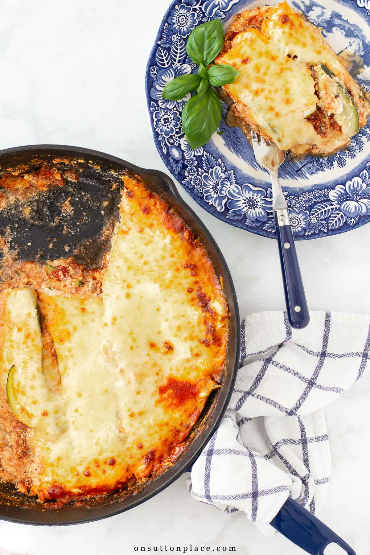 zucchini lasagna recipe in skillet and serving on plate