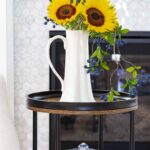 tiered sidetable with fall vignette sunflowers in tall pitcher